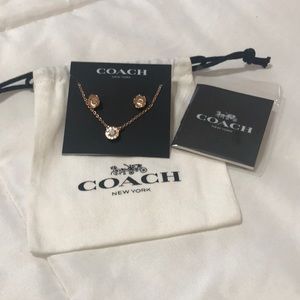 Coach pierced earrings and a pendant necklace.  Everything is rose gold plated.